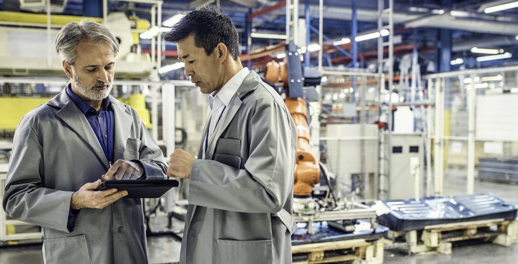 Two electrical engineers planning control system design