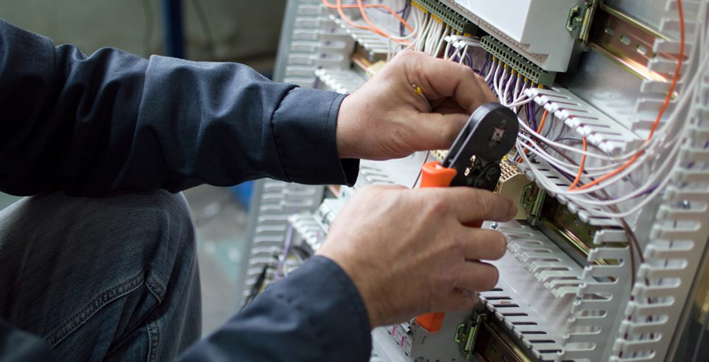 electrical engineer working on an industrial control panel